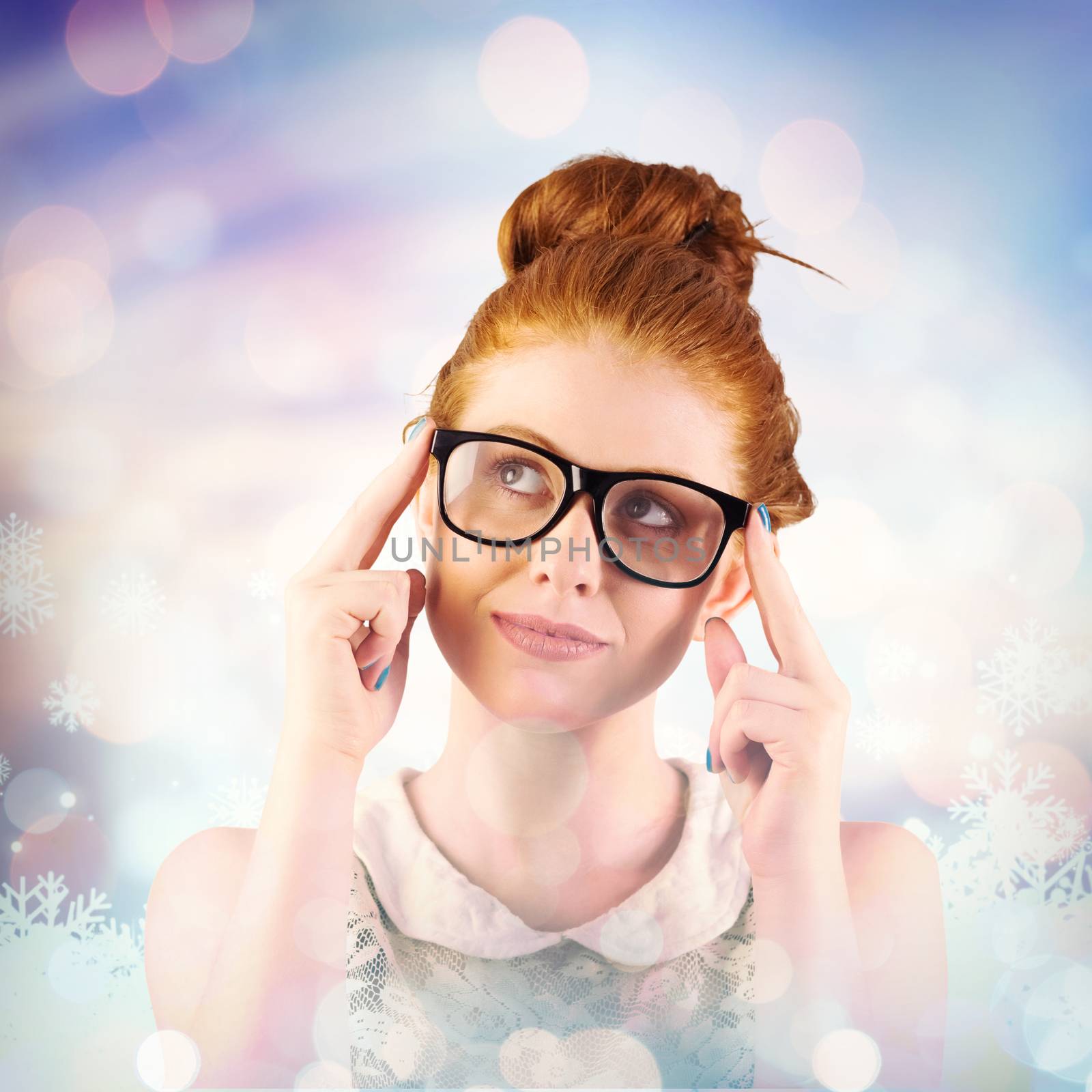 Hipster redhead looking up thinking against snowflake pattern
