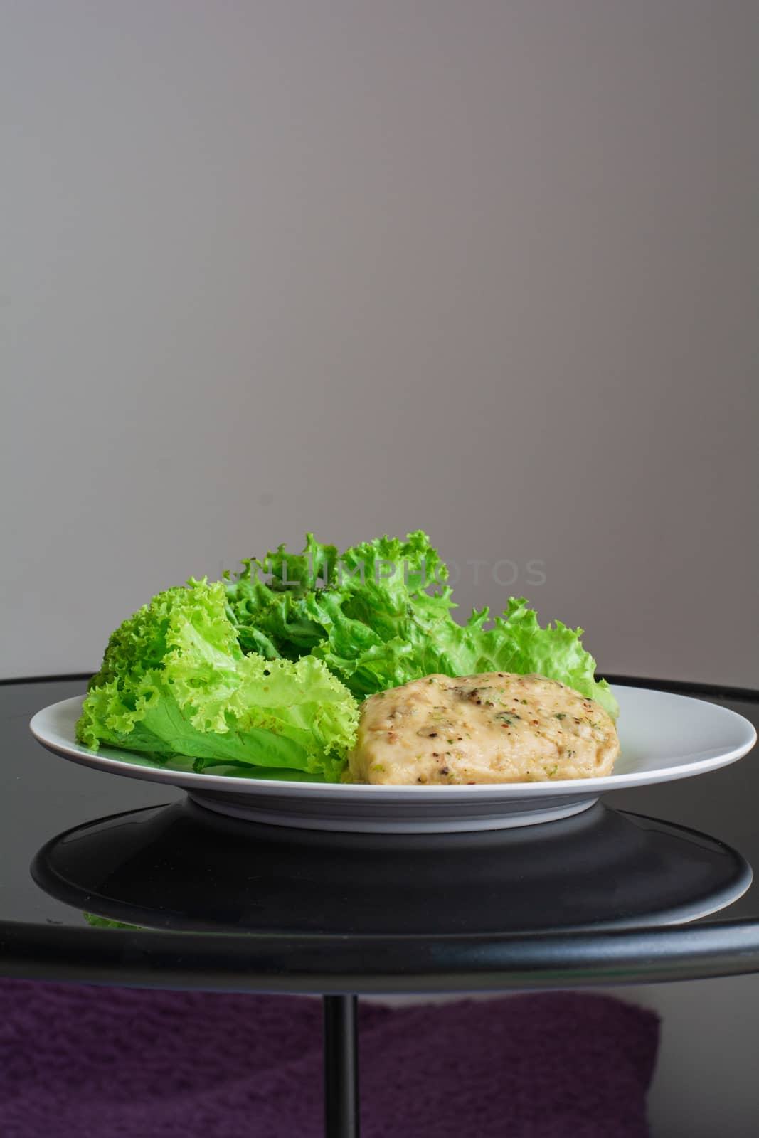 Chicken breast steak with spices serve with fresh green lettuce on white plate. High protein food. Healthy for loose weight.