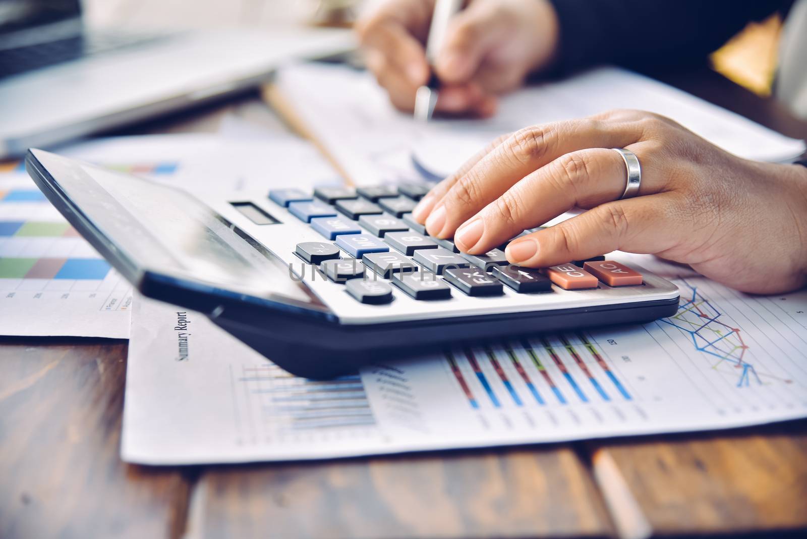 Businessman are working with a calculator and document. Meeting report in progress. in office business concept