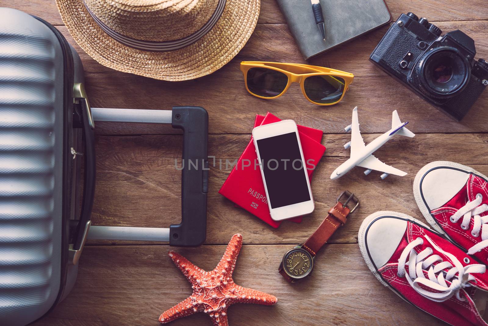 Travel accessories on wooden floor ready for travel by photobyphotoboy