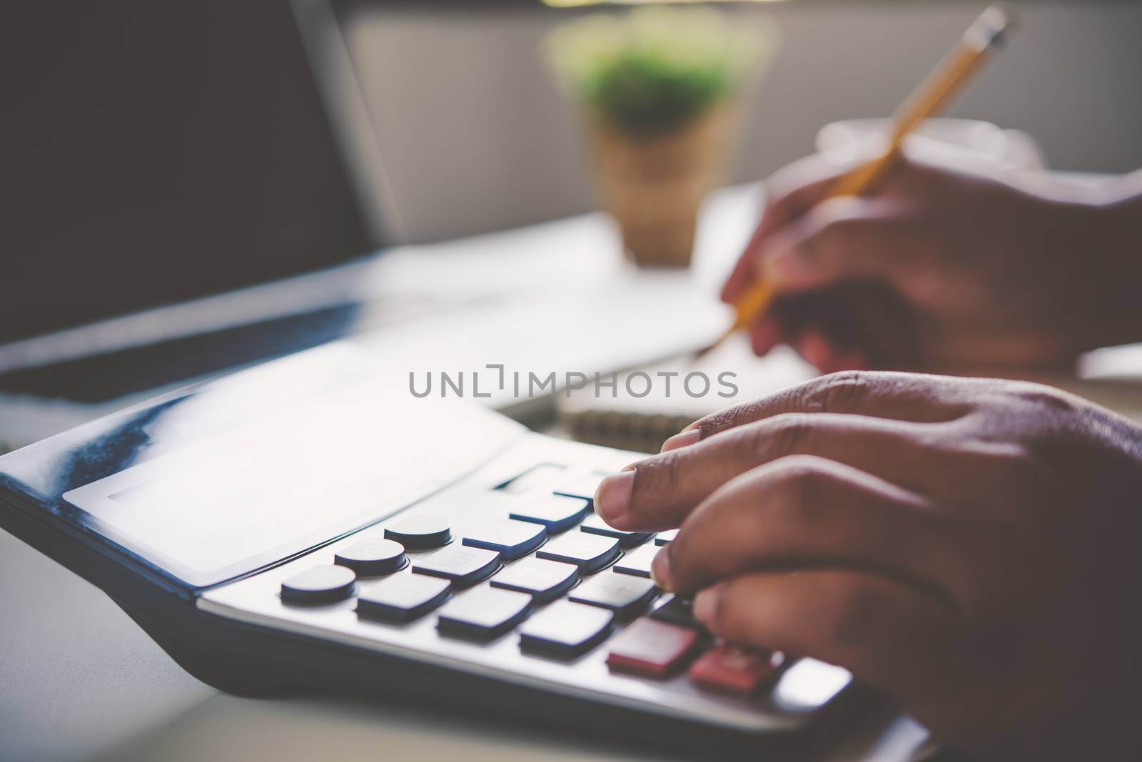Businessman are working with a calculator and document. Meeting report in progress. in office business concept