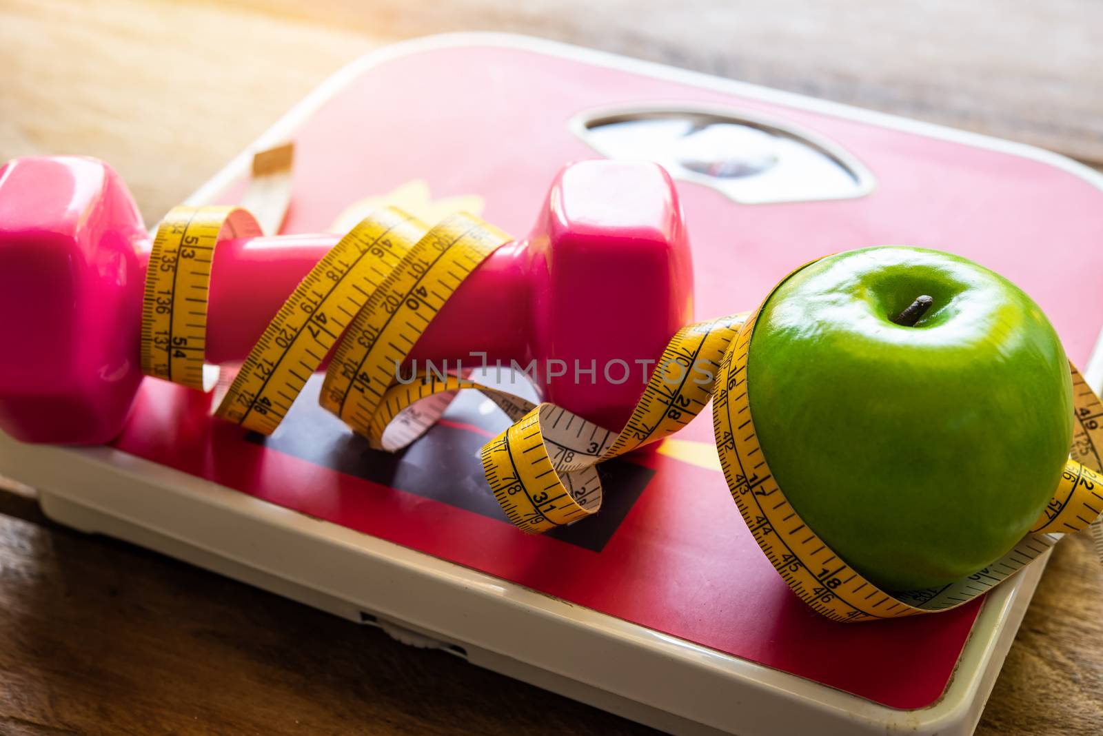 fitness concept with Exercise Equipment on wooden background.