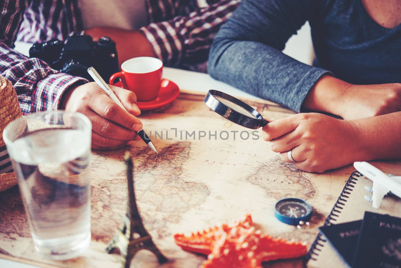 Travelers are planning a trip by searching the route on the map and searching for information on the internet.