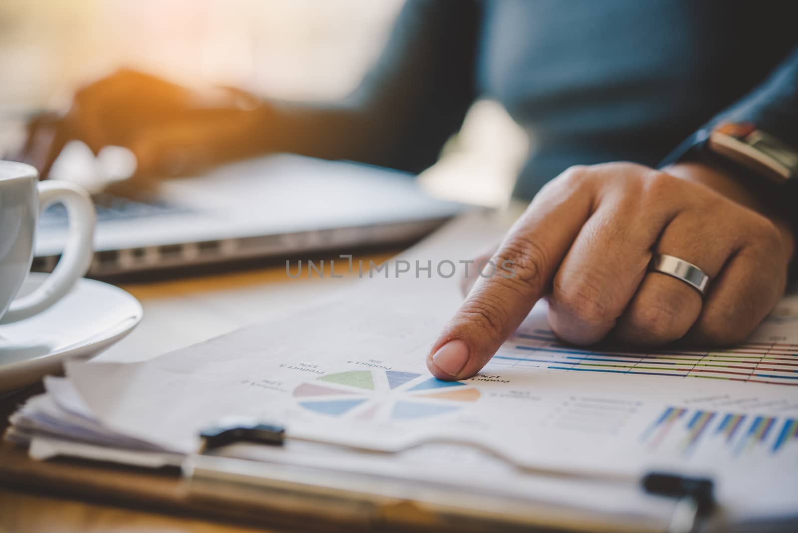 Business man working with document financial in open space office. Meeting report in progress. 