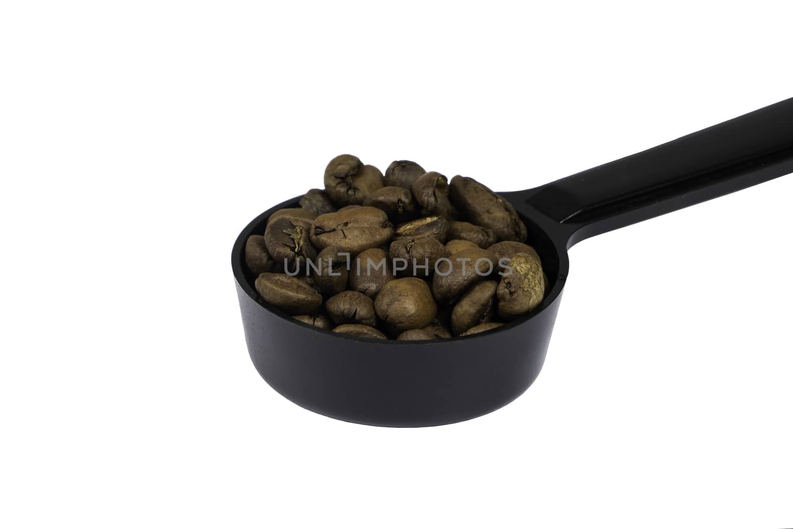 Fully Roasted Coffee Beans in spoon isolate by draftseptember