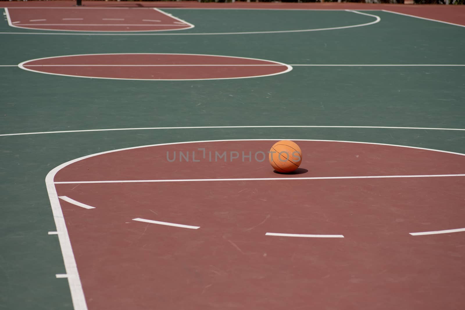 Basketball on free throwline en empty court by rushay