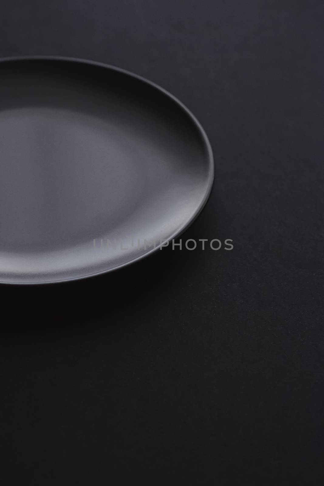 Empty plates on black background, premium dishware for holiday dinner, minimalistic design and diet by Anneleven