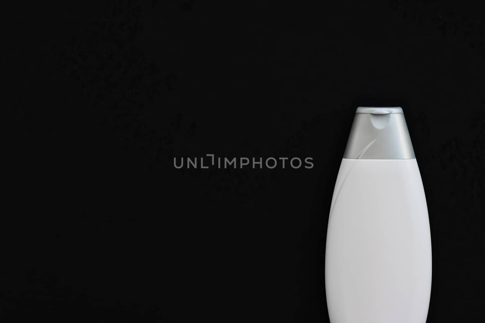 Blank label cosmetic container bottle as product mockup on black background, hygiene and healthcare