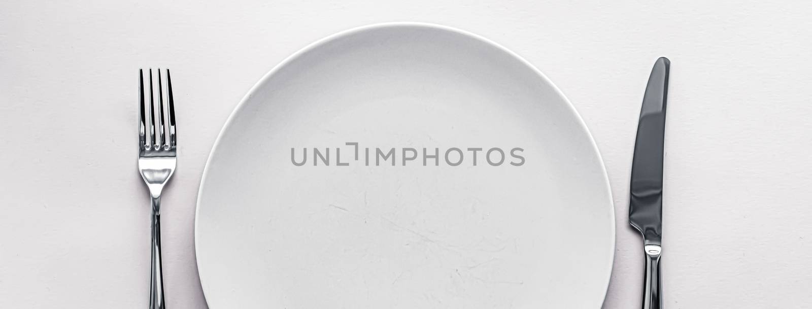 Empty plate and cutlery as mockup set on white background, top tableware for chef table decor and menu branding design