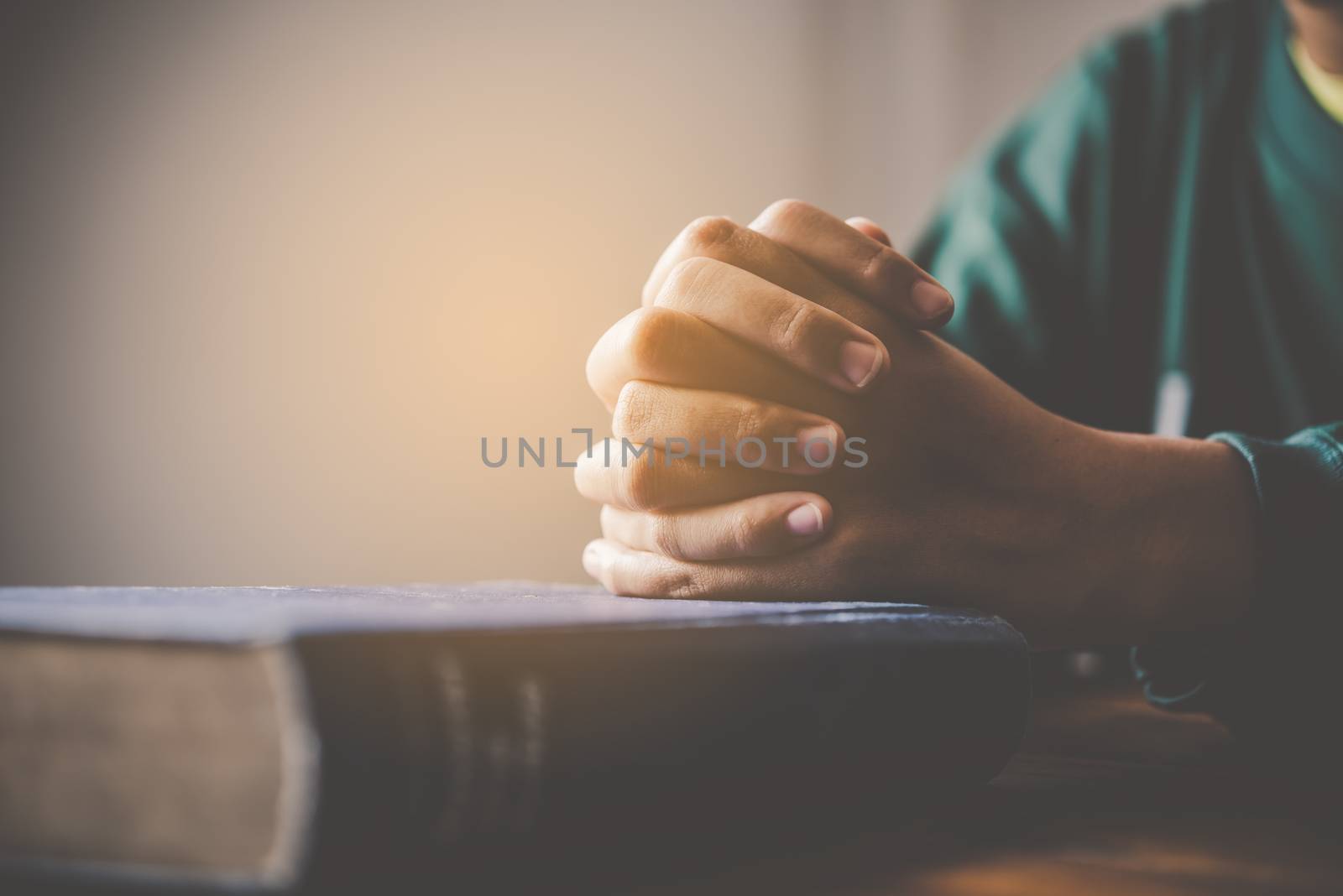 hands woman laying on the biblical while praying for christian religion blessings and Pray to God
