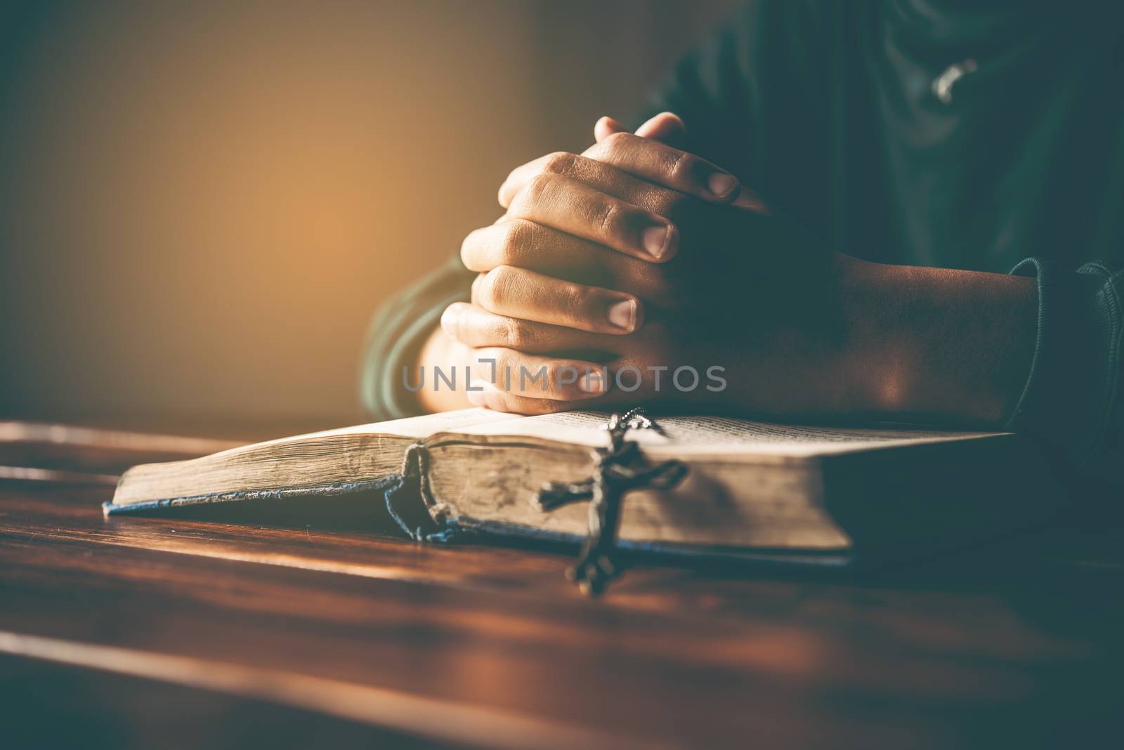 hands woman laying on the biblical while praying for christian religion blessings and Pray to God