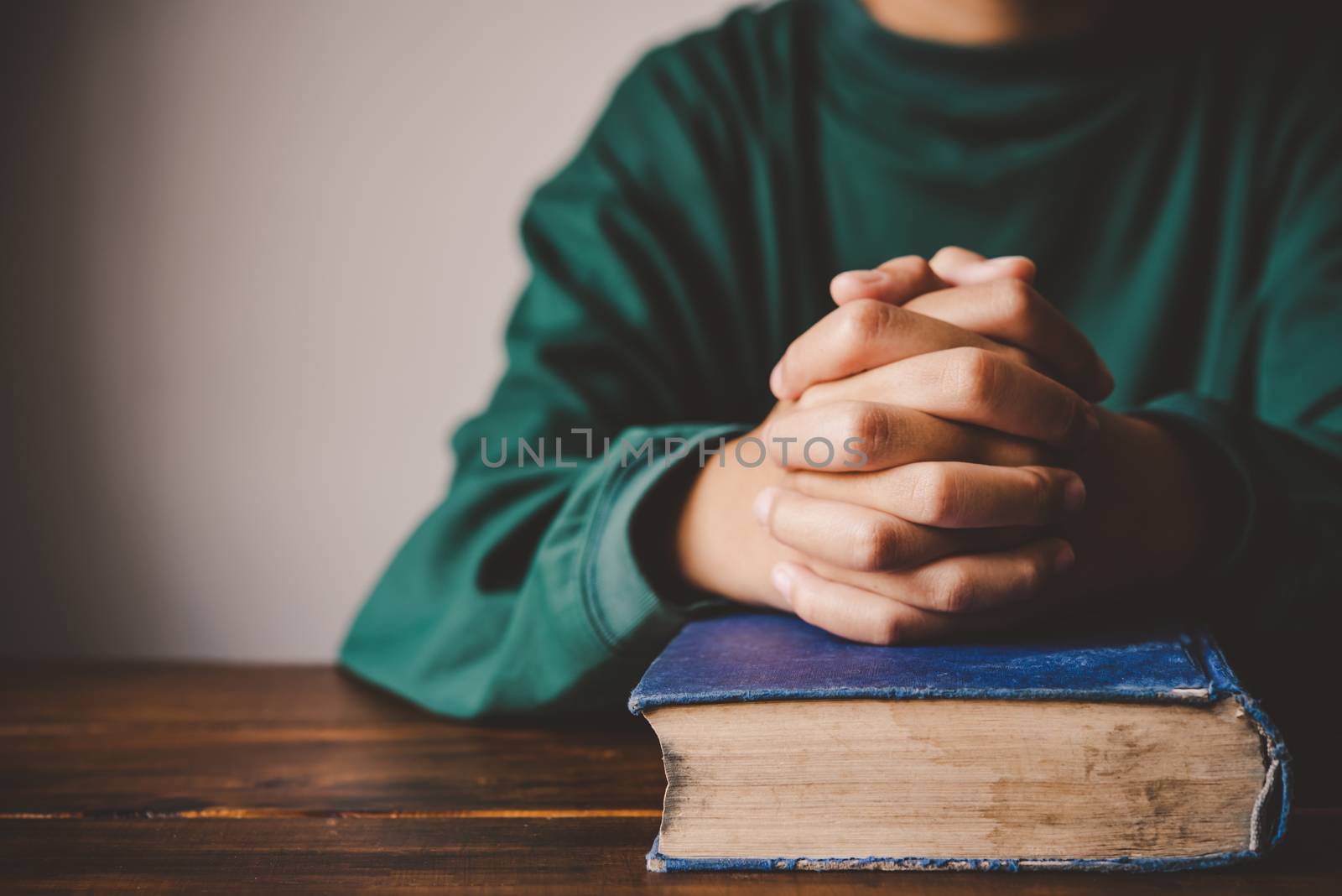 hands woman laying on the biblical while praying for christian religion blessings and Pray to God