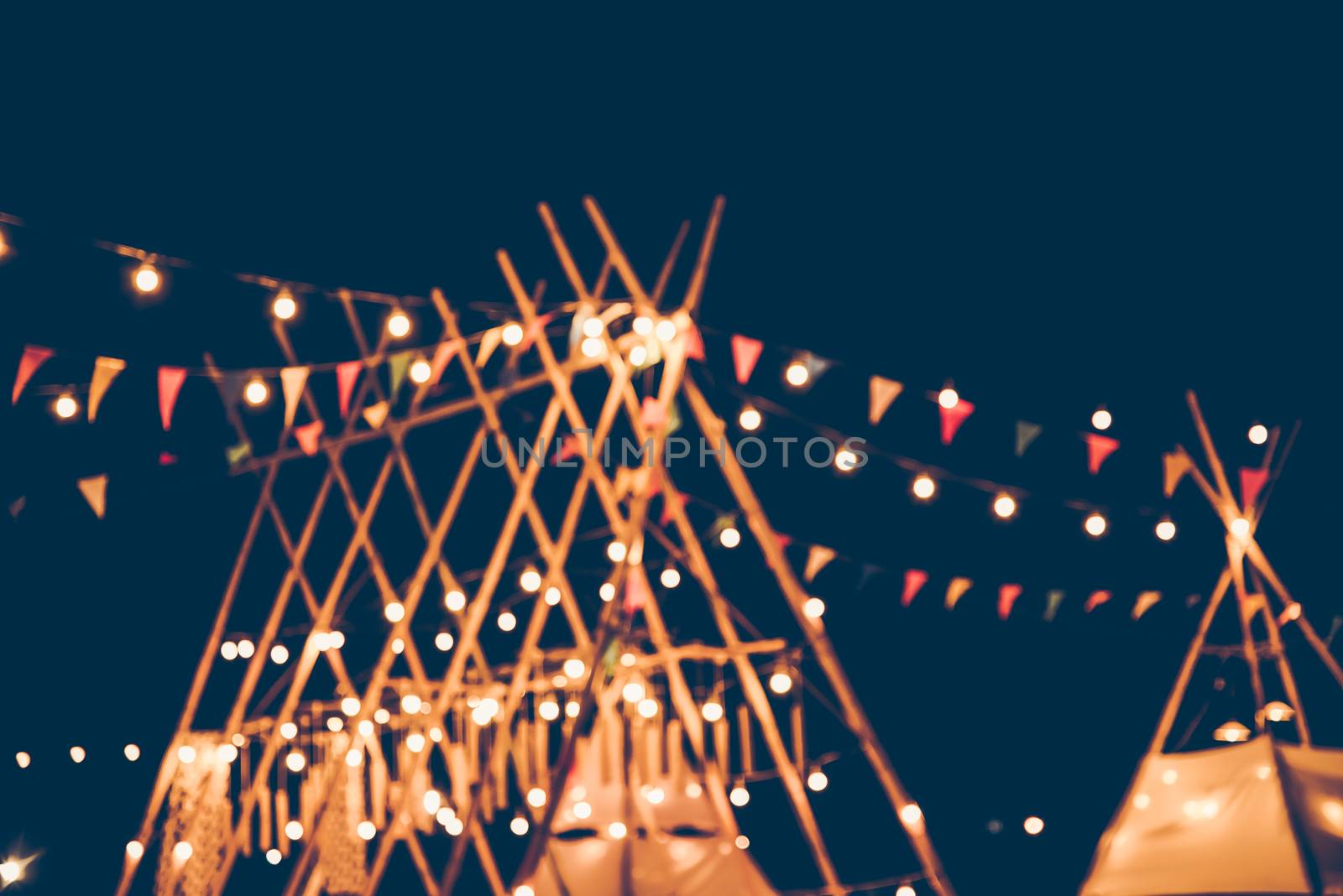Blurred images of the background party in the festive festivities during the night, consisting of people and glittering bokeh.