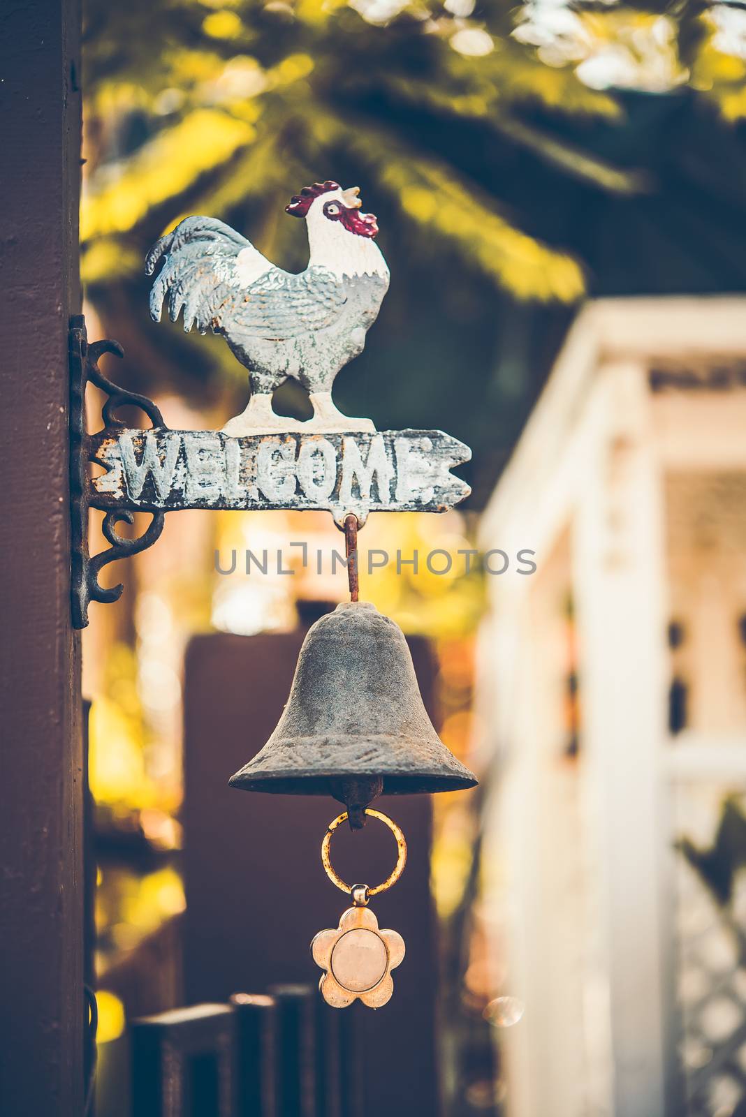 vintage wooden sign "Welcome" with a bell under the sign on door by photobyphotoboy