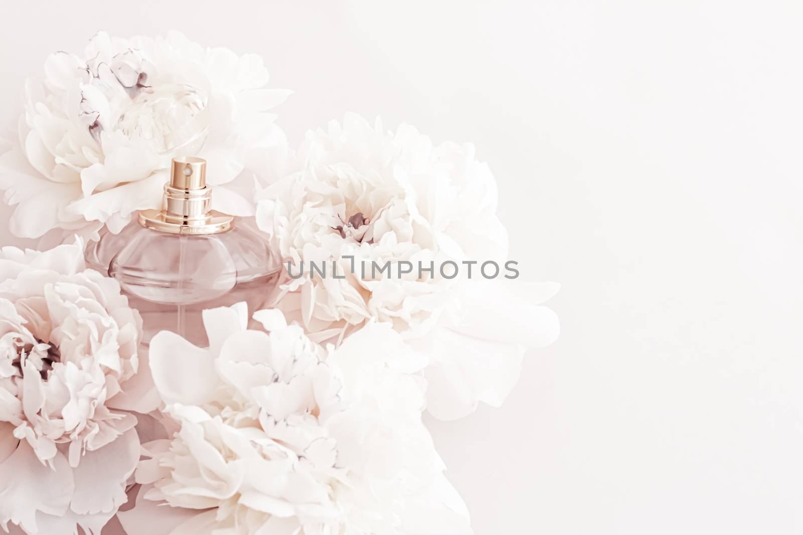 Fragrance bottle as luxury perfume product on background of peony flowers, parfum ad and beauty branding design