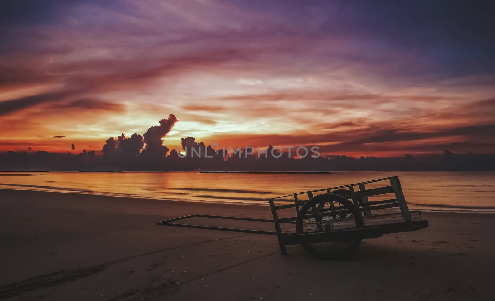 a cart on sand and beach sunrise