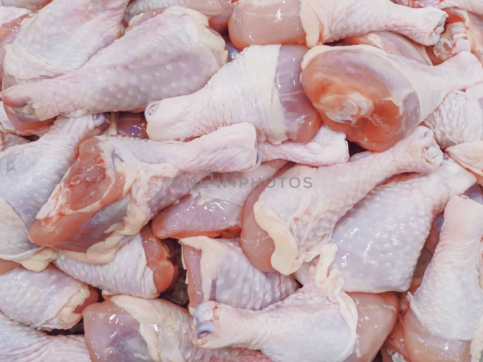 fresh raw chicken legs at market