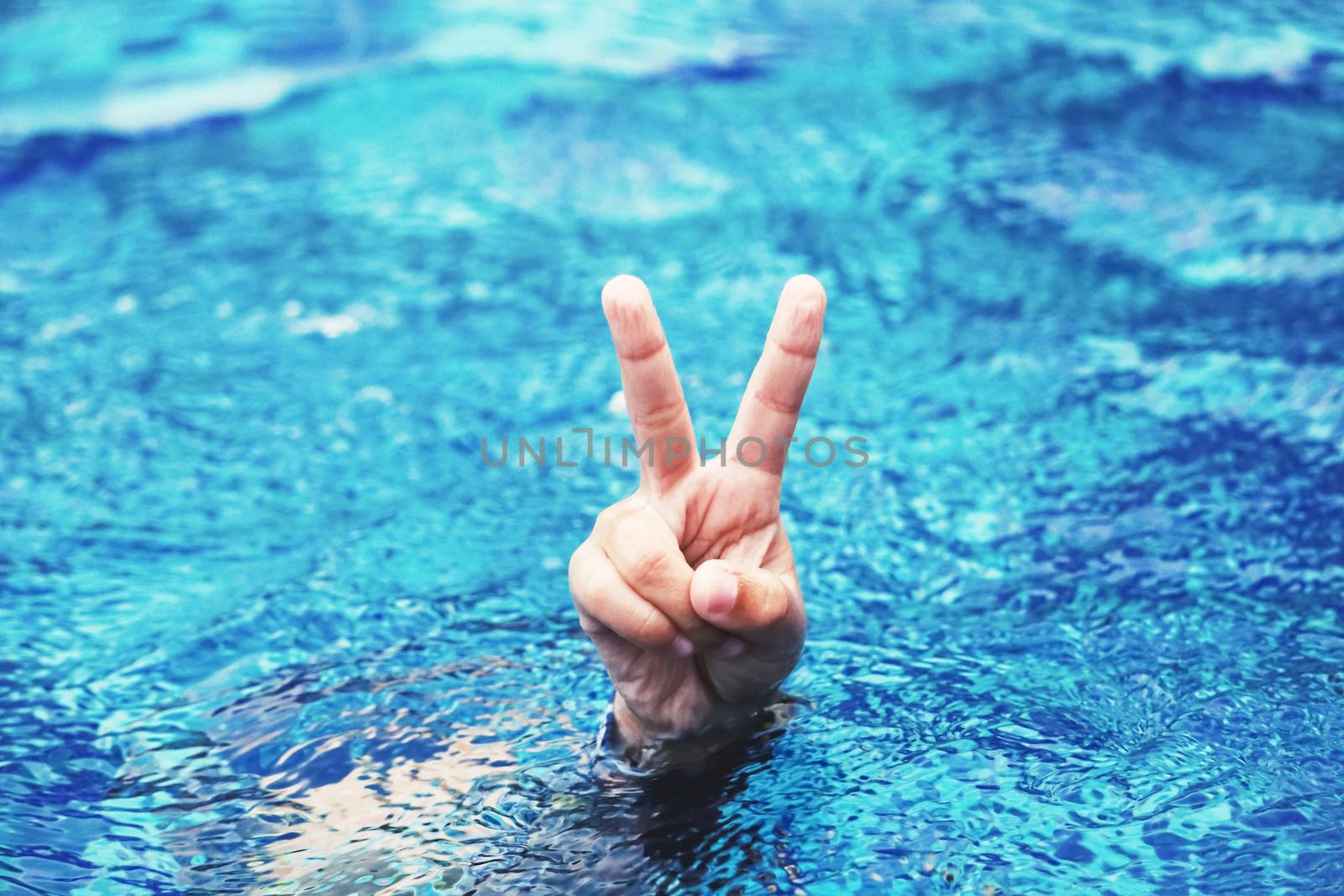 hand gesture of happy kid in swimming pool