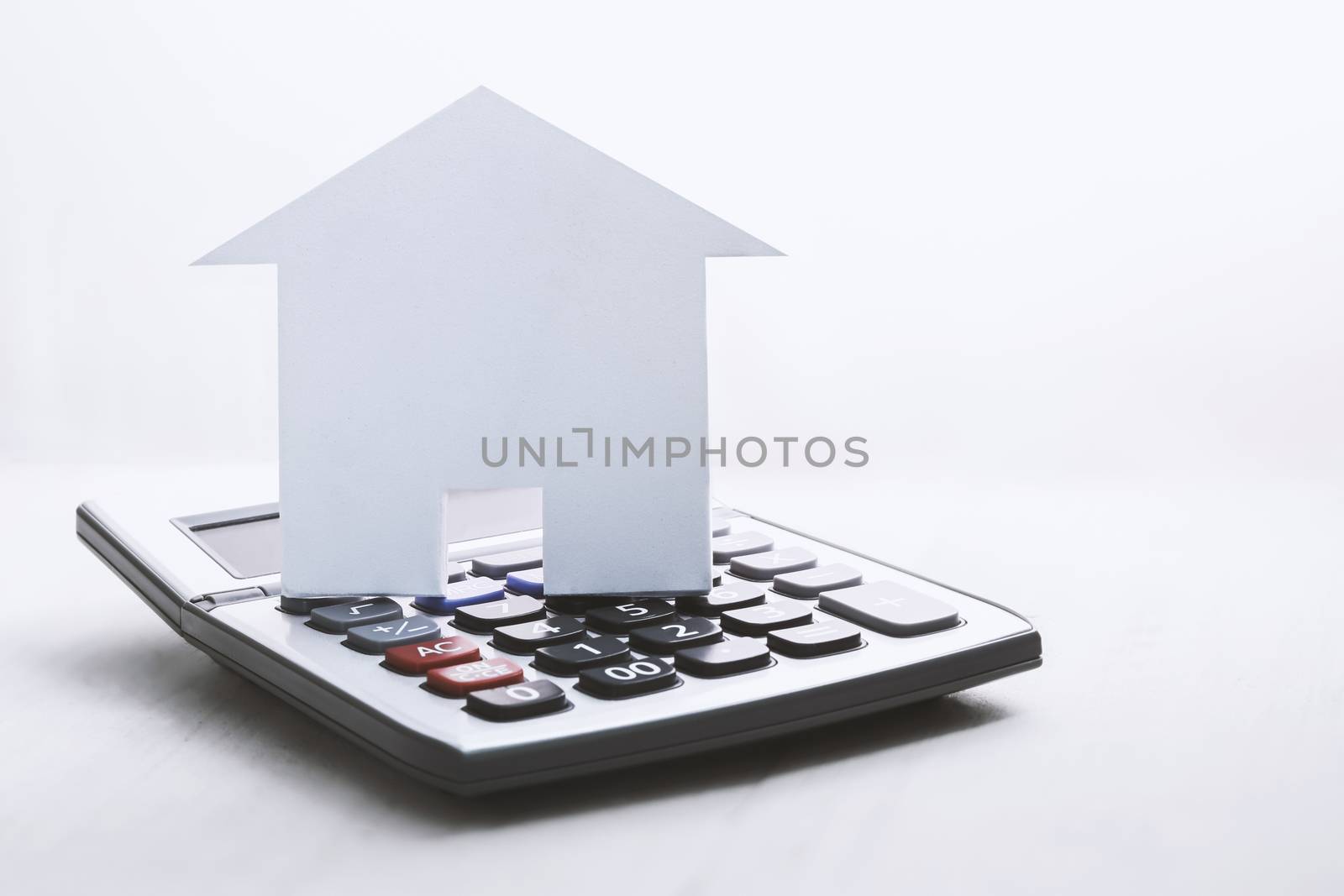 house symbol with calculator on white by winnond