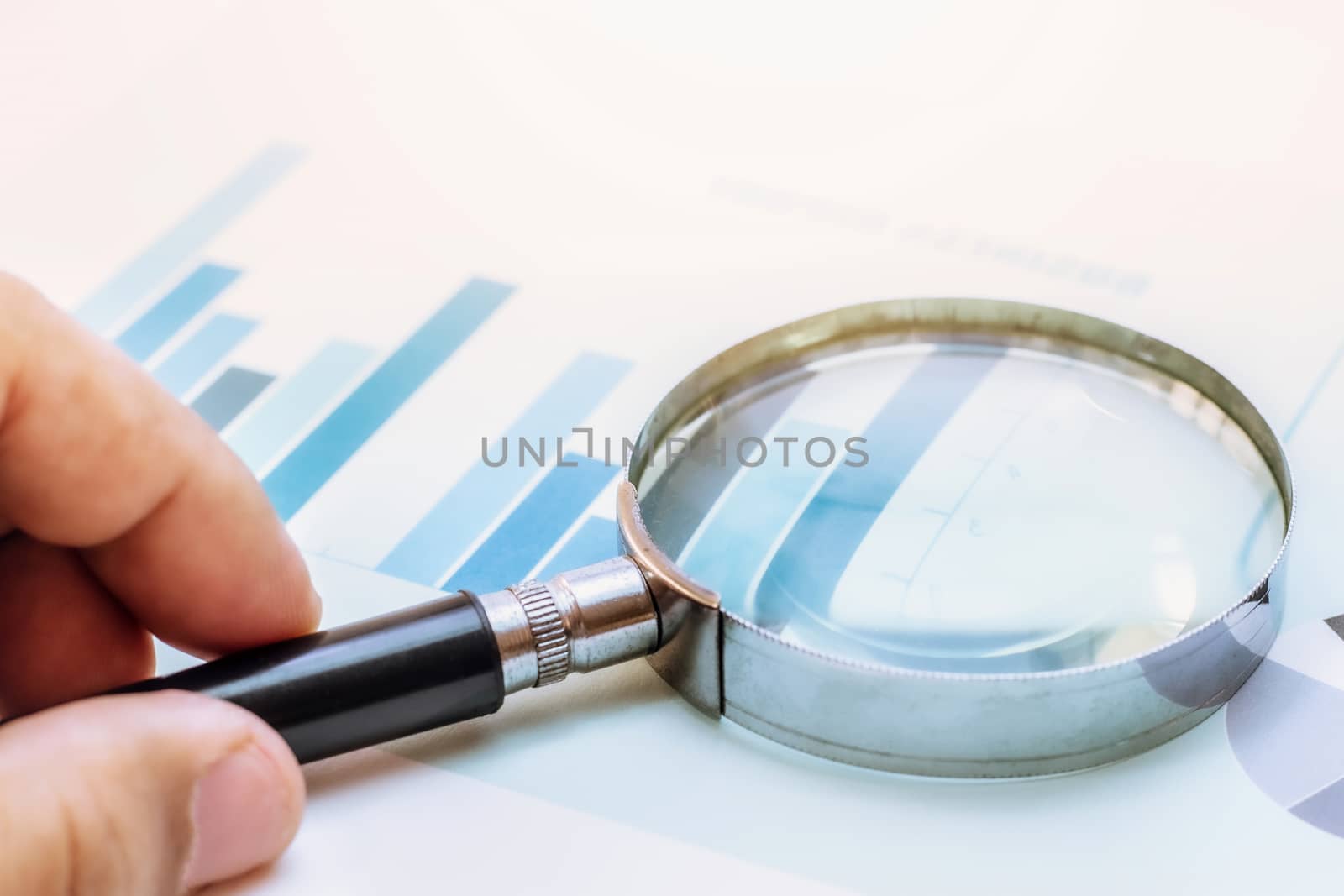 magnifying glass focus on business financial report