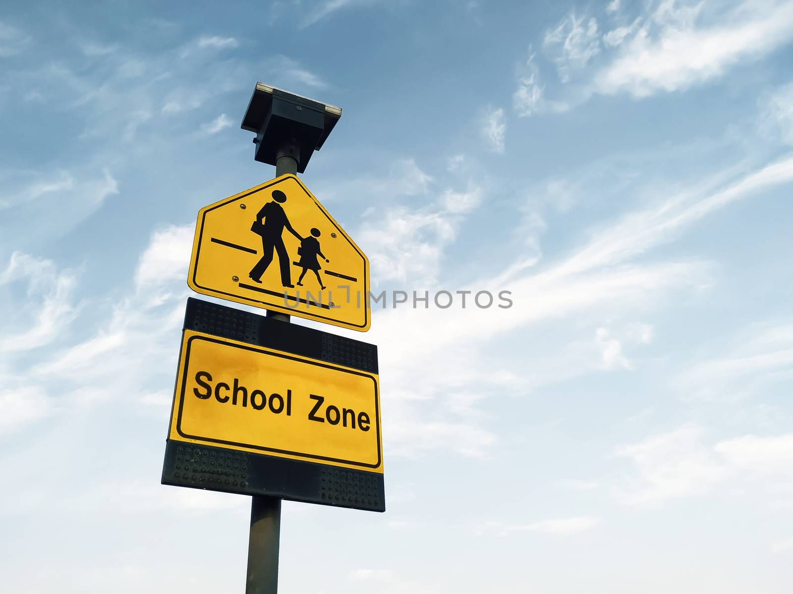 school zone sign against sky background