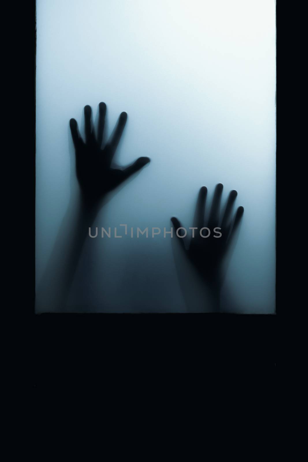 shadow of hand touch behind frosted glass by winnond