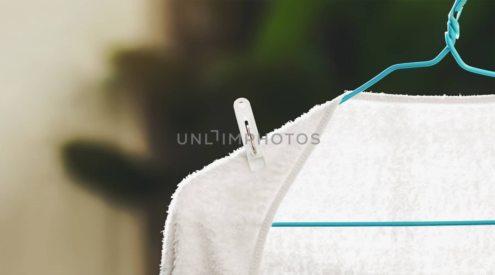 white towel drying on hanger with blur background