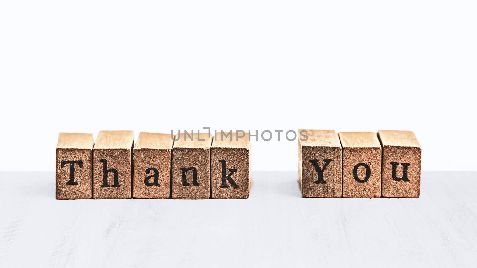 word thank you on wood block