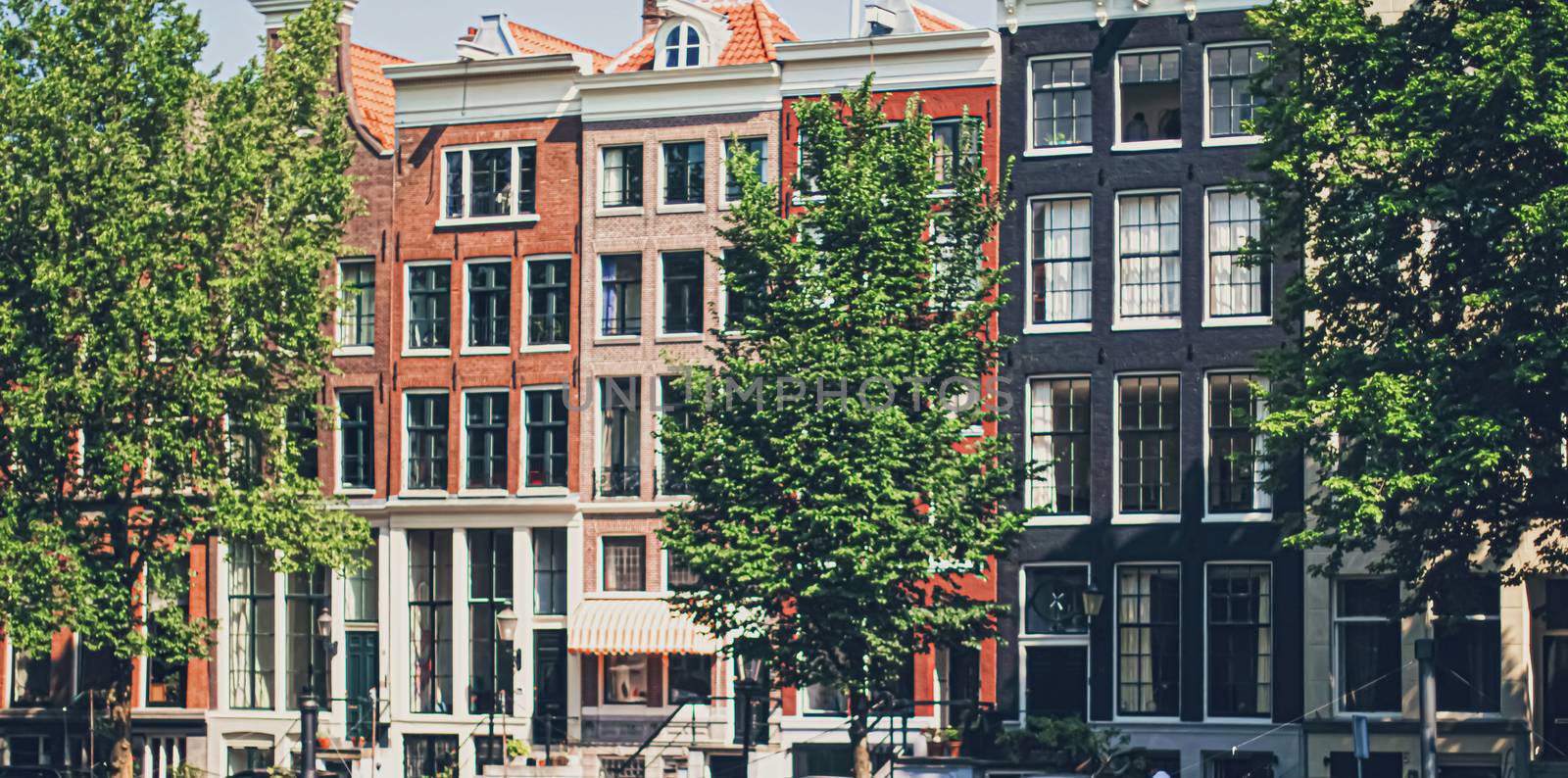 Main downtown street in the city center of Amsterdam in Netherlands on sunny day