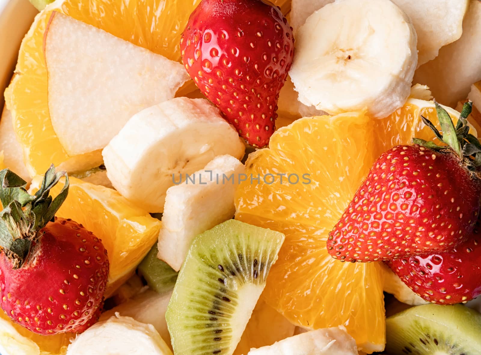 Healthy food. Bowl of fresh mixed fruit salad top view