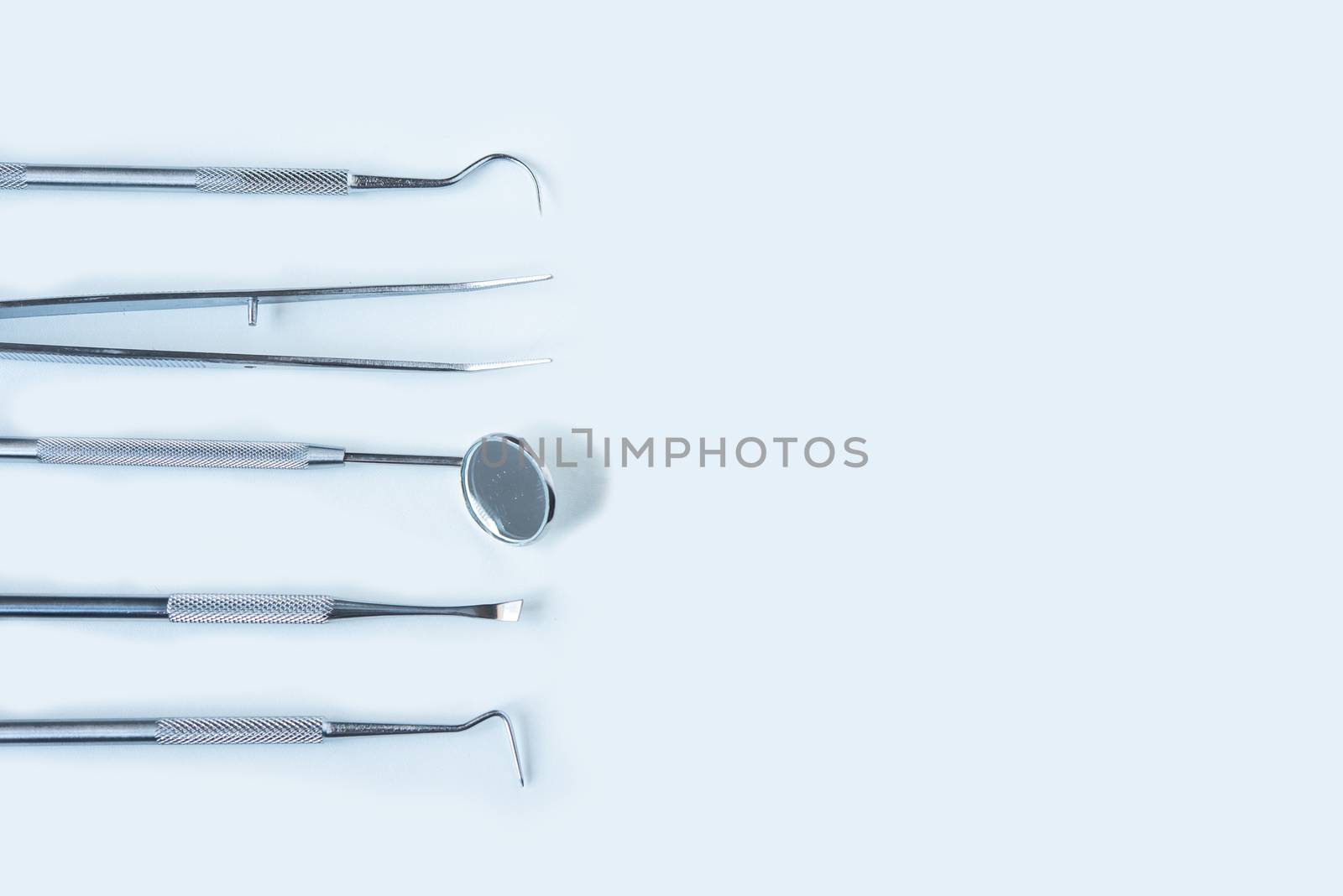  close up dentist  tools for teeth care at white background top view 