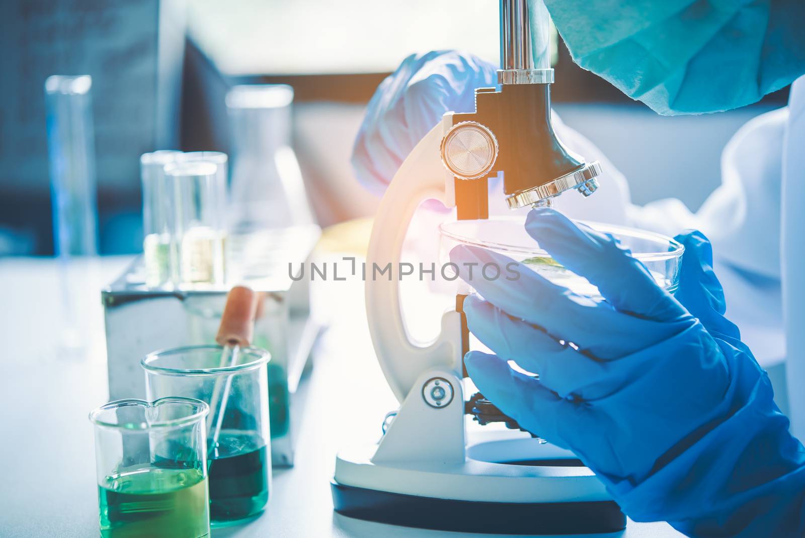 scientist student  looking through a microscope in an experiment research in laboratory,studying and researching