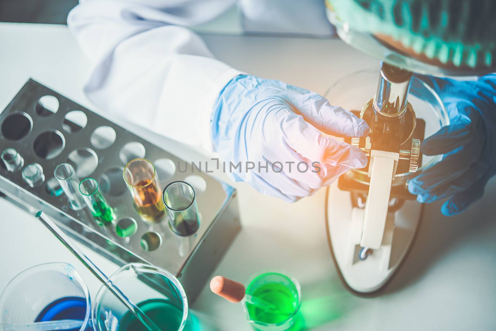 scientist student  looking through a microscope in an experiment research in laboratory,studying and researching