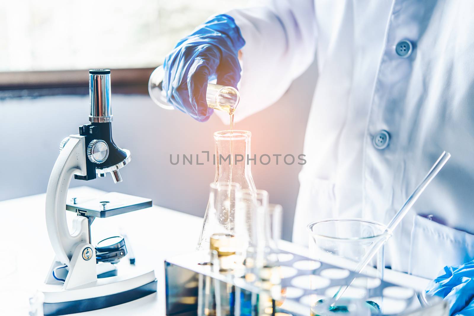  Equipment and science experiments oil pouring scientist with test tube yellow making research in laboratory.