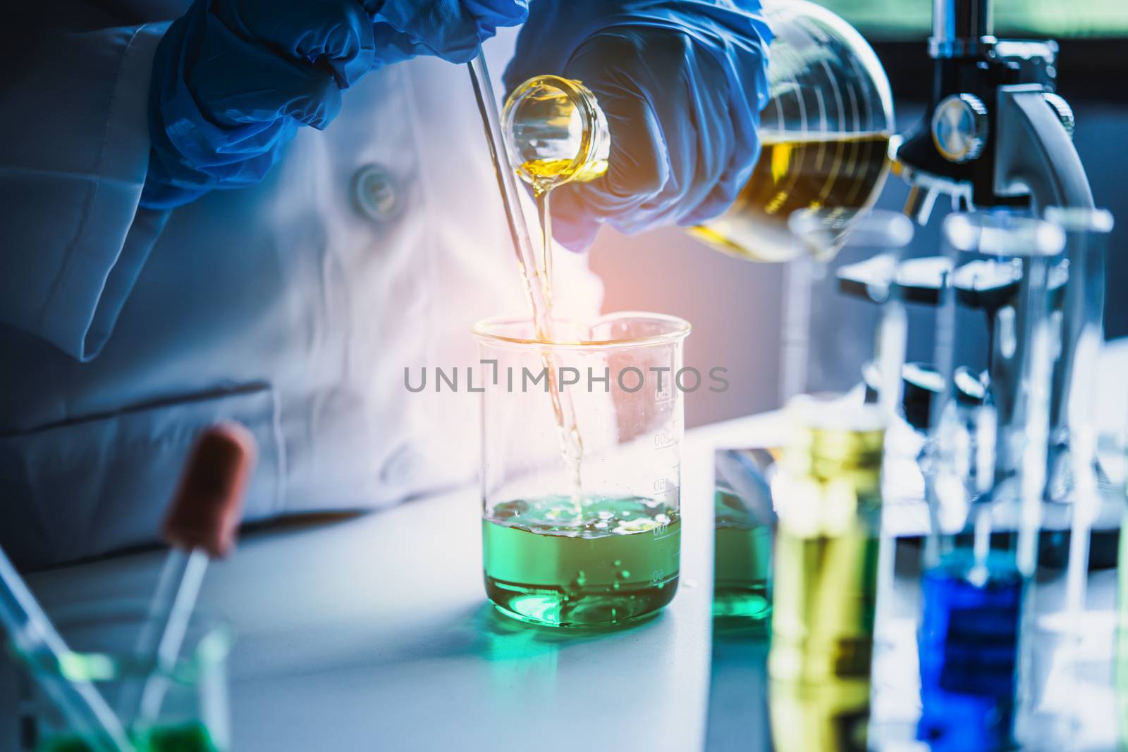  Equipment and science experiments oil pouring scientist with test tube yellow making research in laboratory.