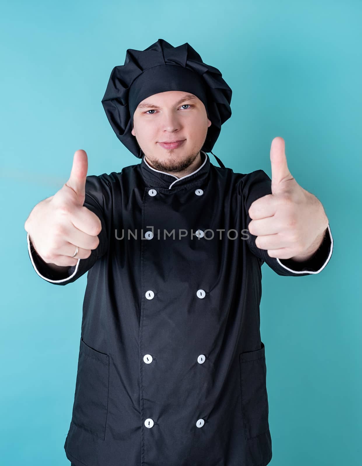 Male chef showing thumbs up isolated on blue with copy space by Desperada