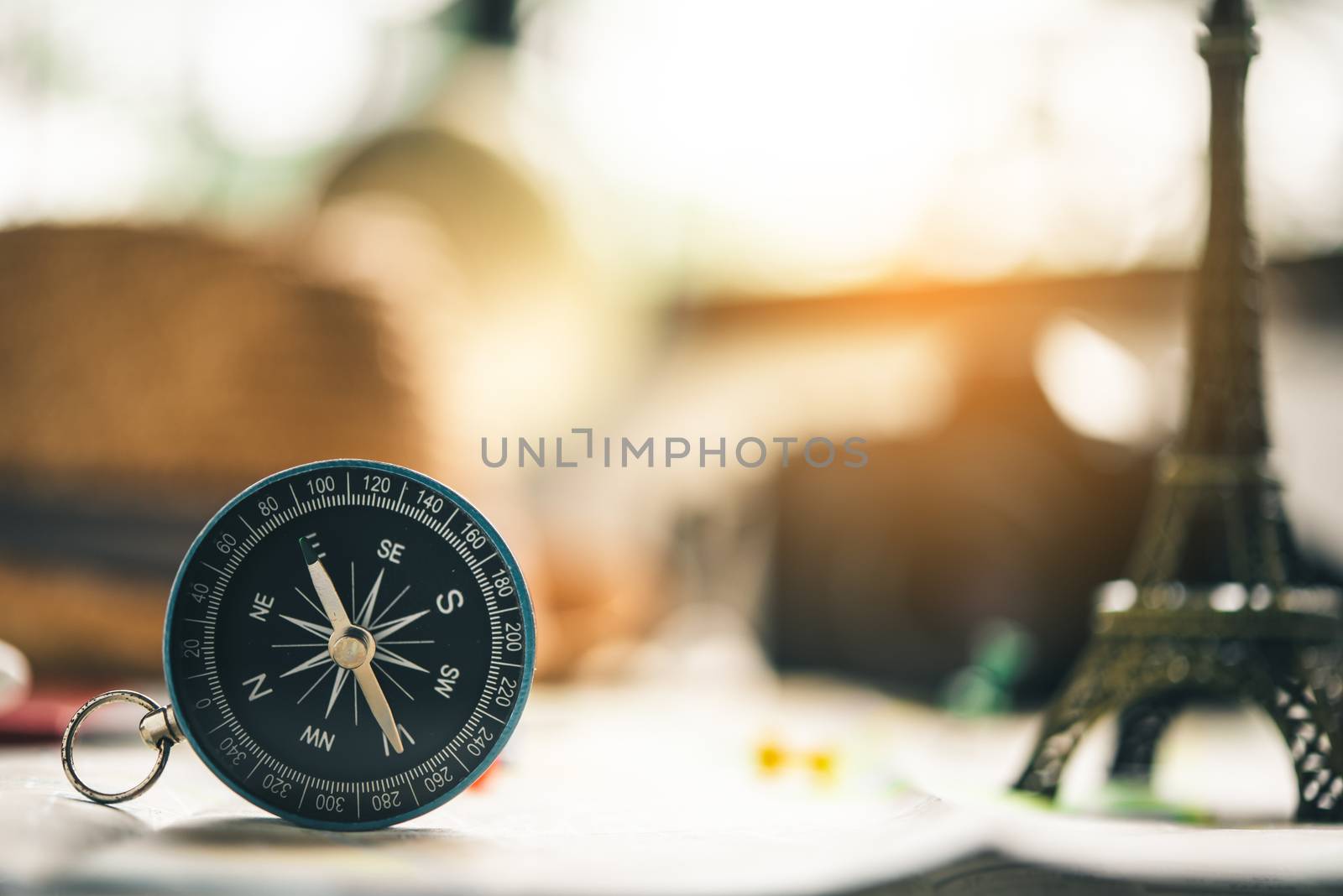 The blue compass is placed on the world map. by photobyphotoboy