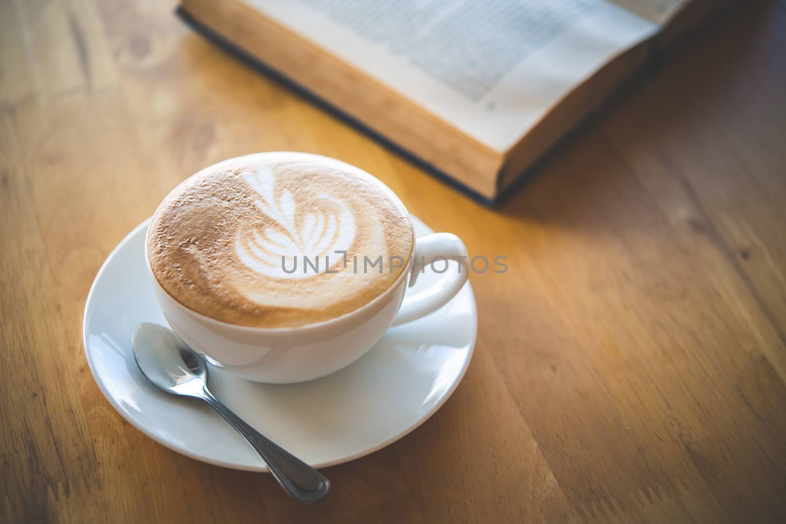 Latte coffee in glass placed on wooden floor. by photobyphotoboy