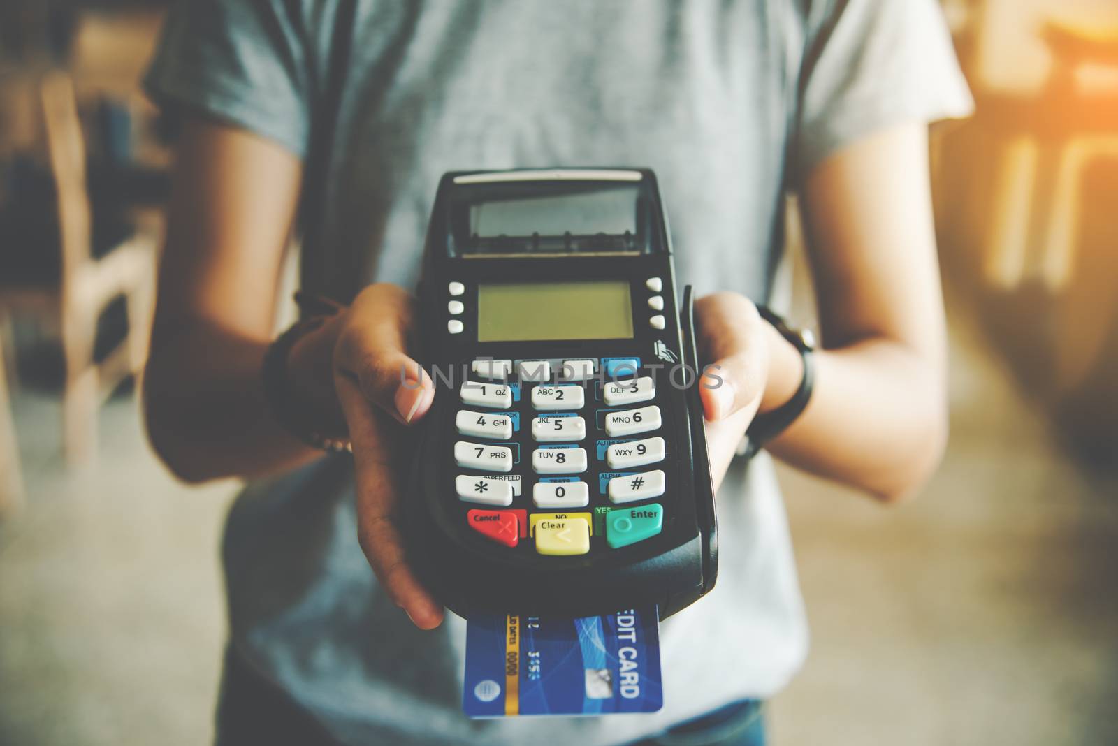 Close up of hand hold credit card swiping machine to pay. Online by photobyphotoboy