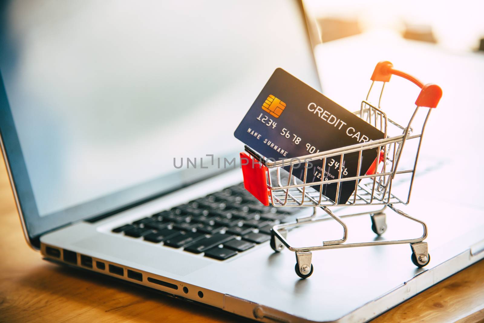 Small shopping cart with credit card on laptop, online shopping and shopping concept