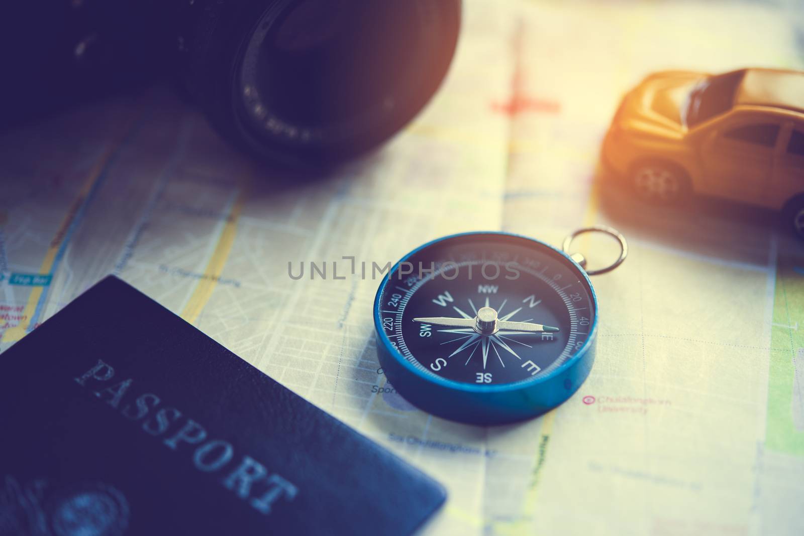The blue compass is placed on the world map. by photobyphotoboy