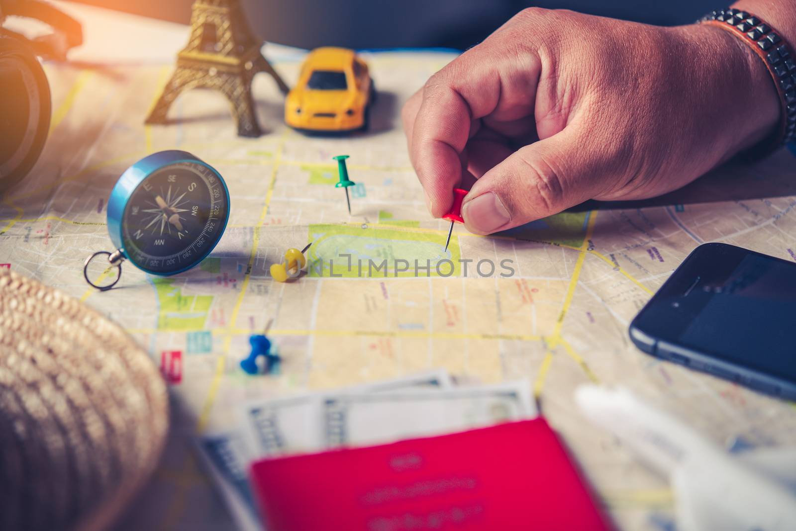 Travelers are planning a trip by searching the route on the map  by photobyphotoboy