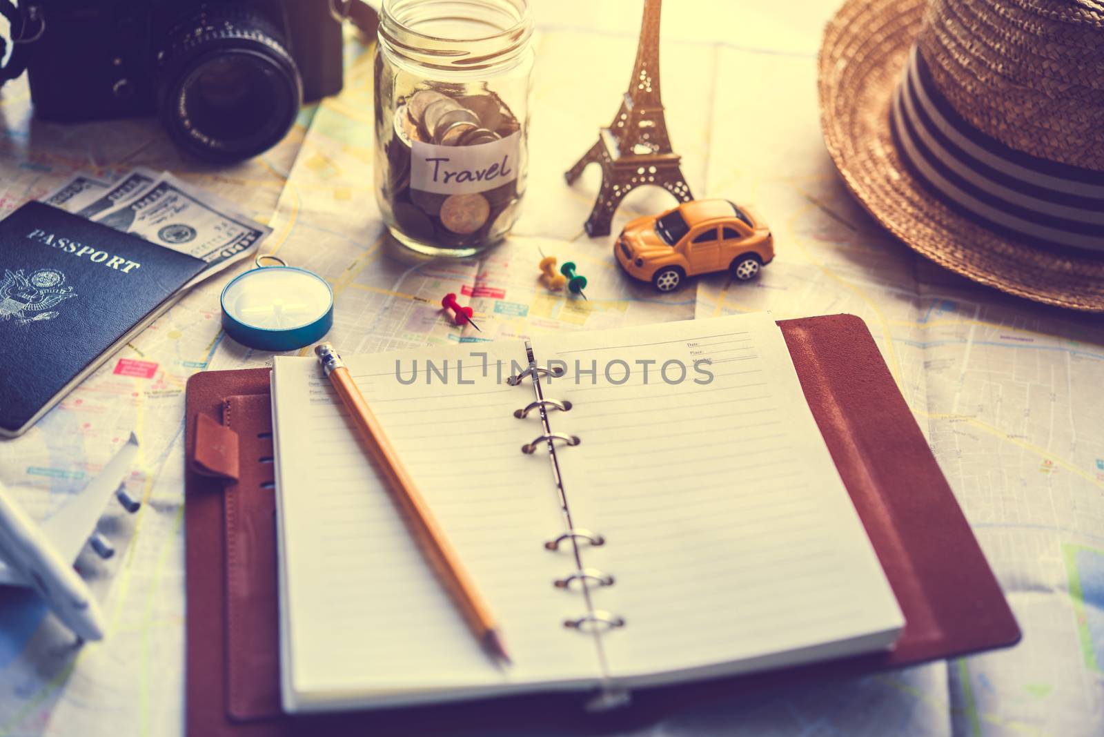 Notebook placed on the map, travel planning by photobyphotoboy