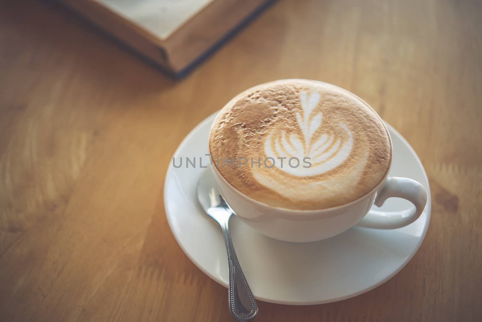 Latte coffee in glass placed on wooden floor. by photobyphotoboy