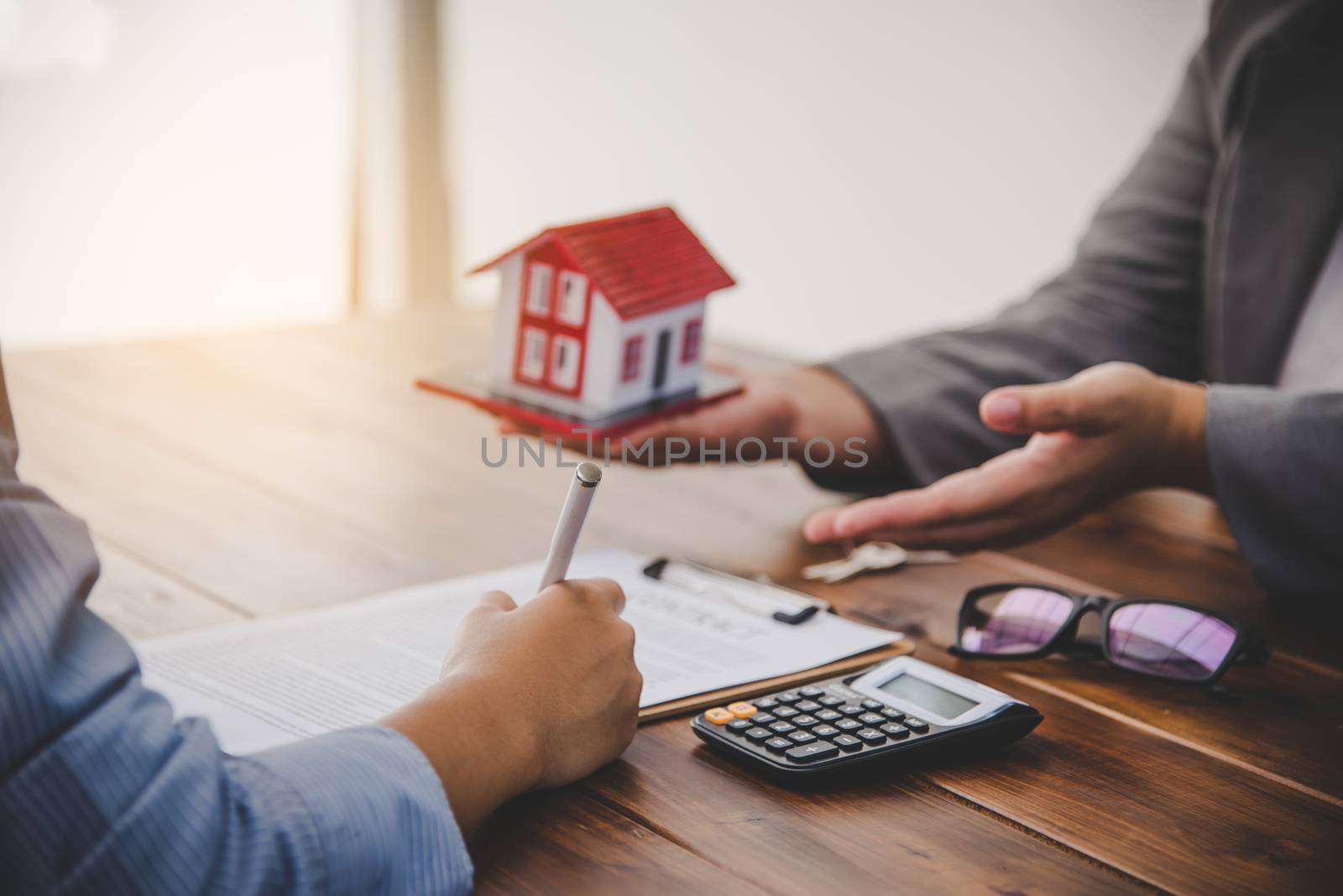 House signers signing signature loan document to home ownership with real estate agents ownership. Mortgage and real estate property investment, home insurance