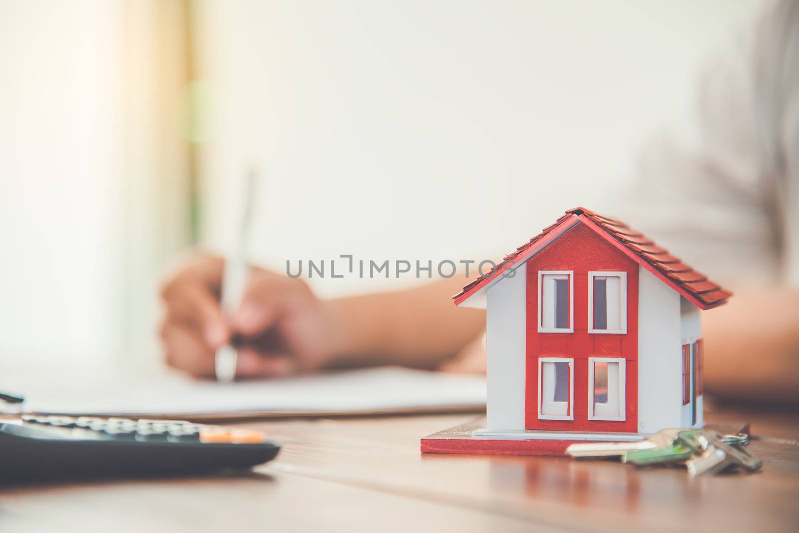 Close up hand  signing signature loan document to home ownership by photobyphotoboy