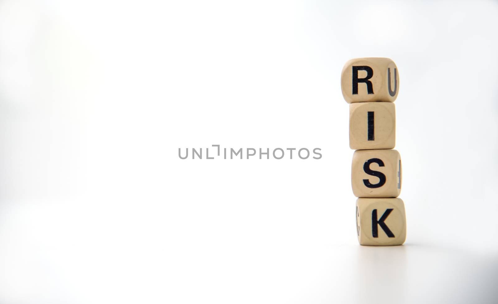 wooden block with the word "RISK". Concept risk management by photobyphotoboy