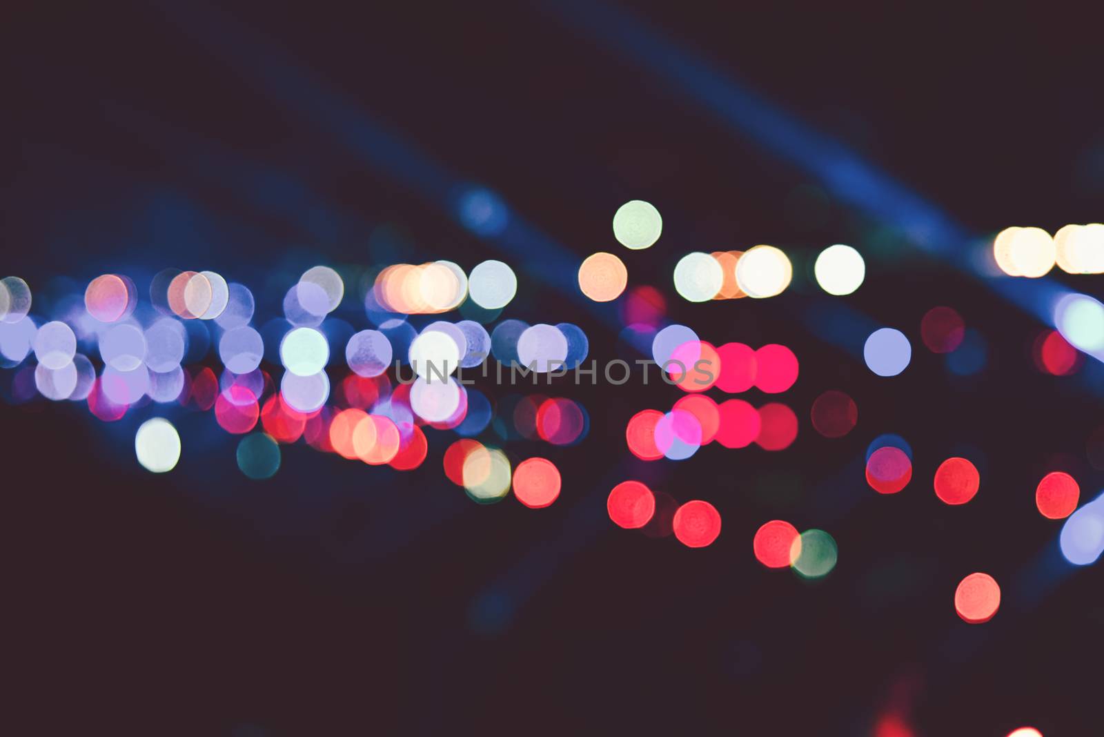 Blurred images of the background party in the festive festivities during the night, consisting of people and glittering bokeh.