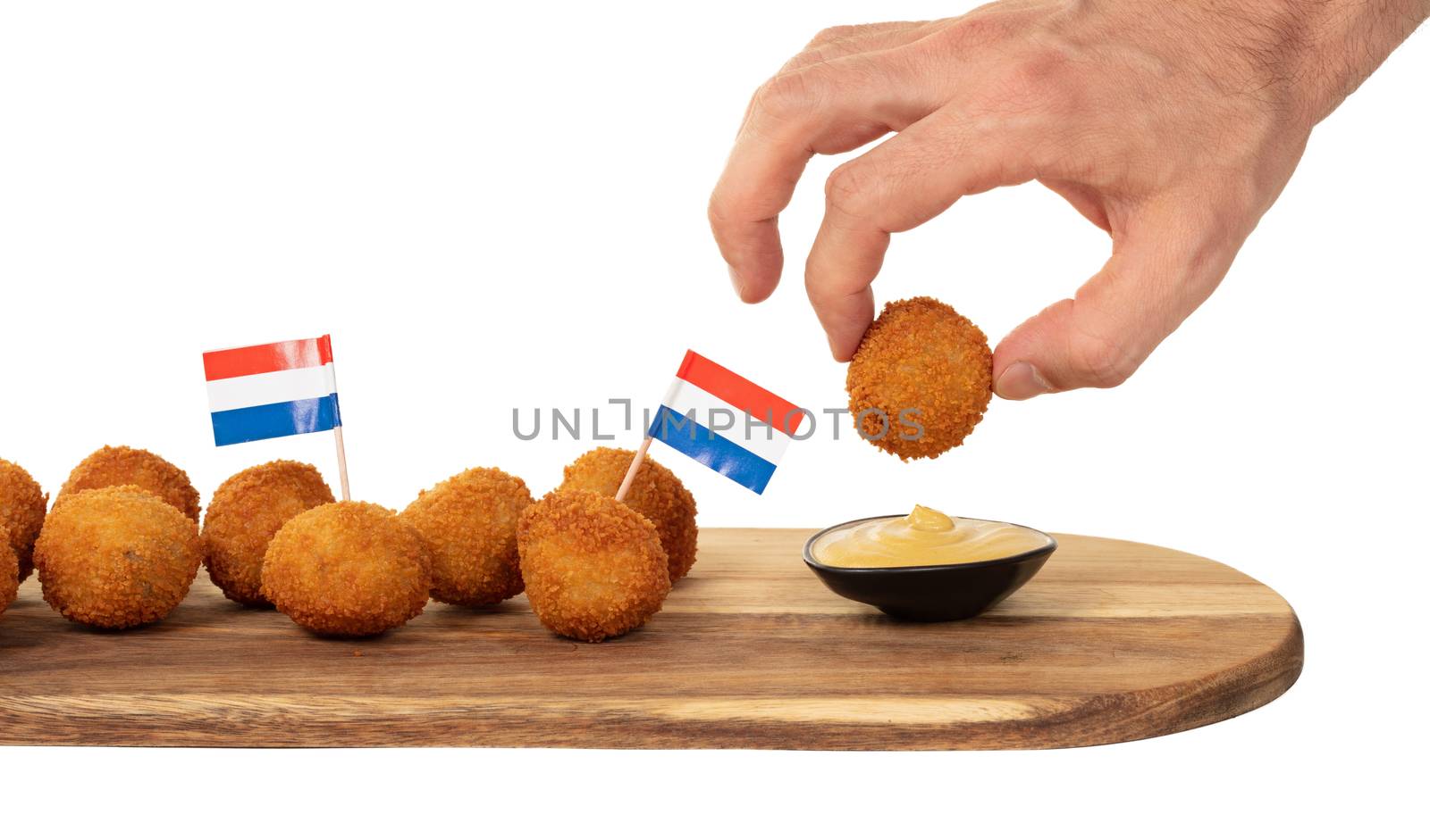 Dutch traditional snack bitterbal in a hand, isolated