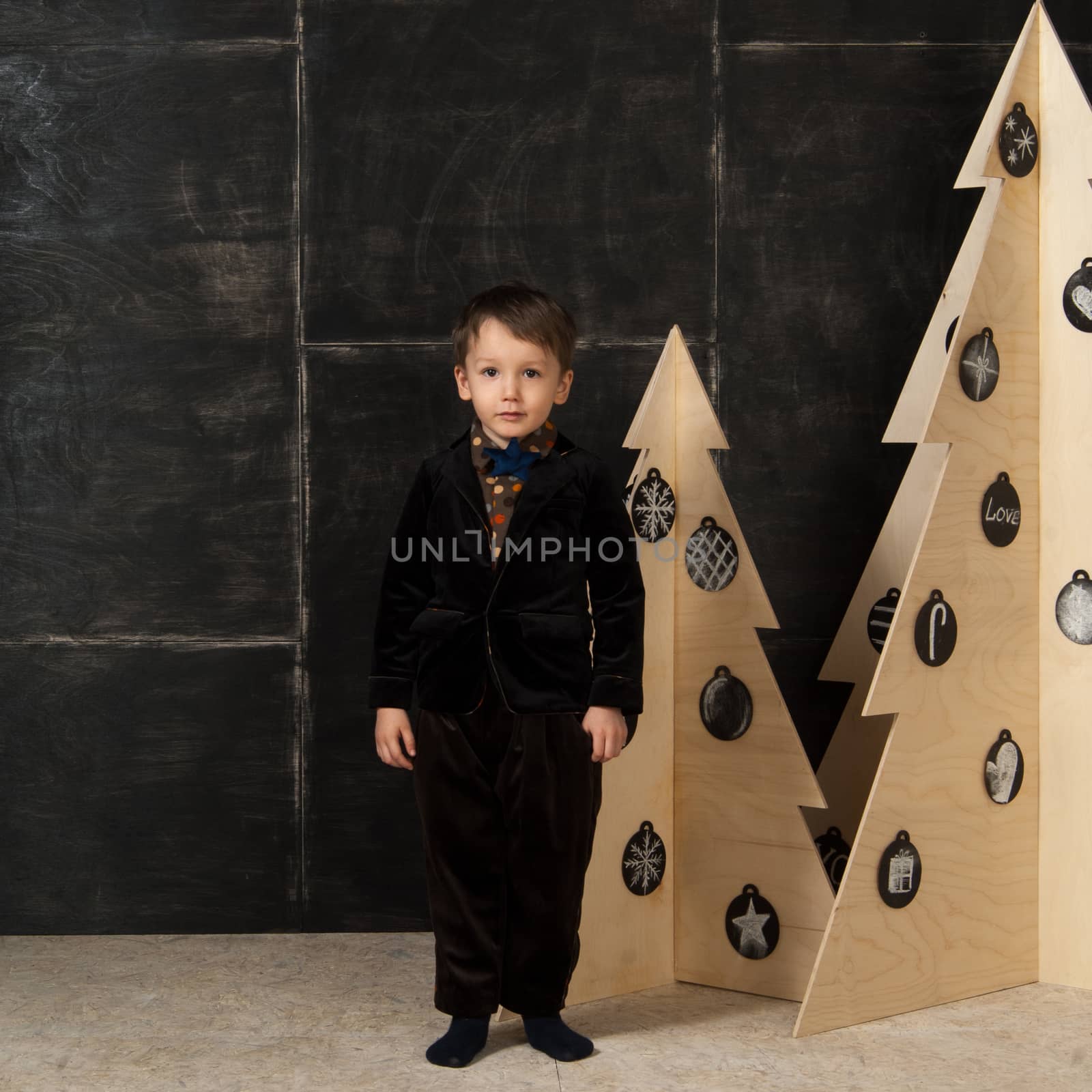 the little boy next to decorative Christmas trees by A_Karim